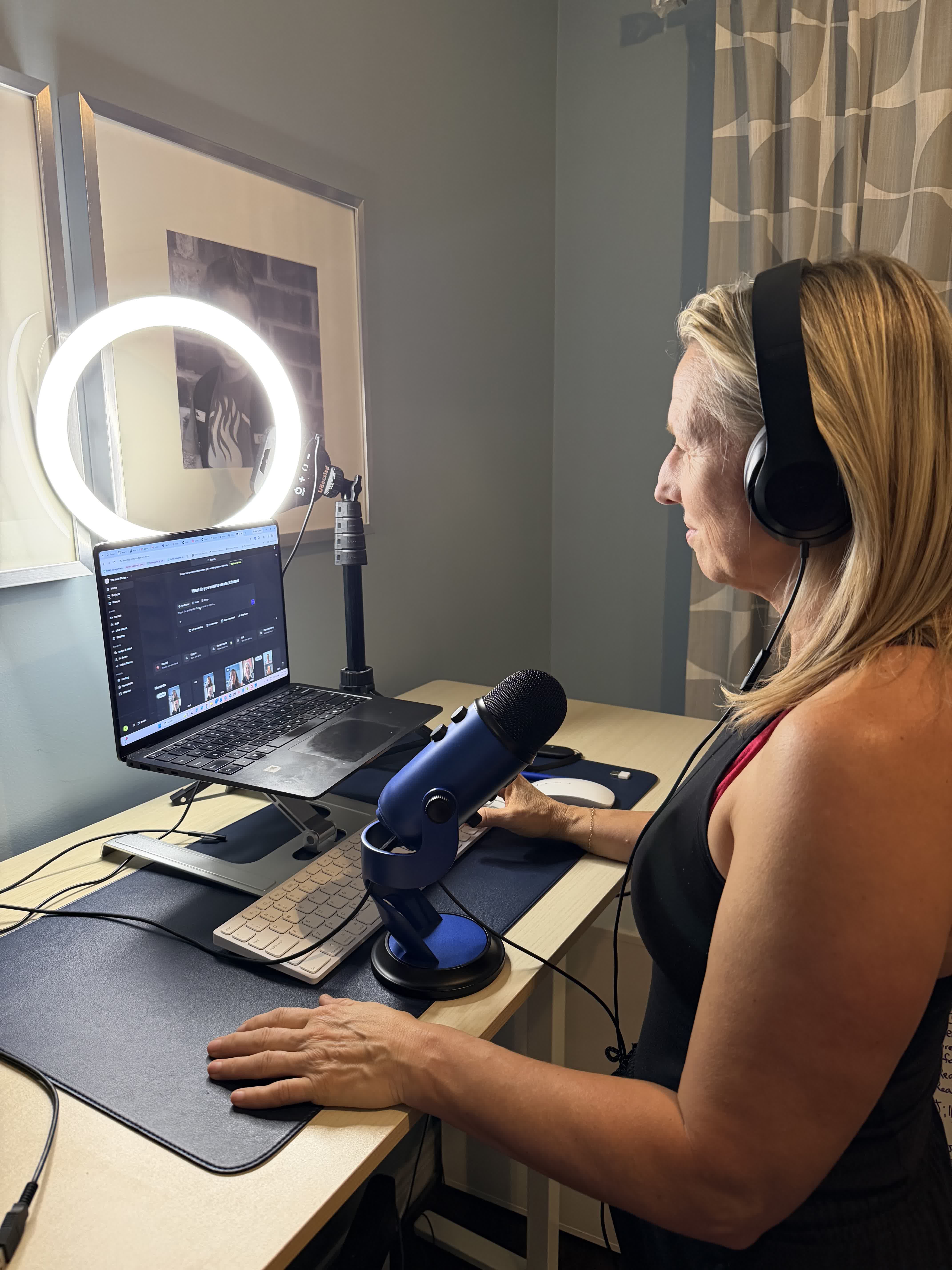 Kristen behind the microphone at her podcast recording desk