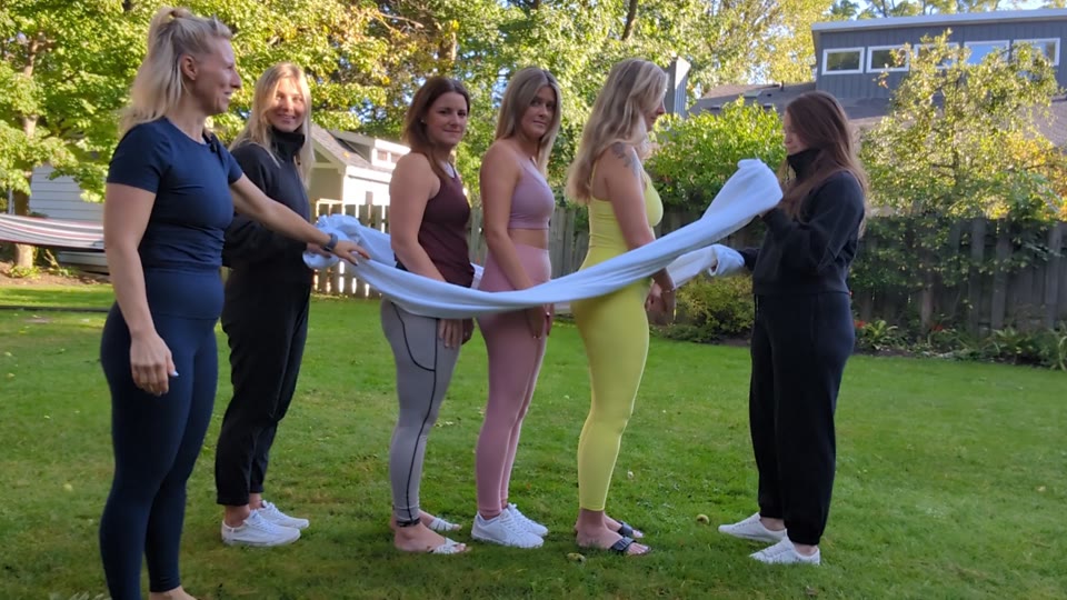 Kristen leading a group demonstration with a large sheet